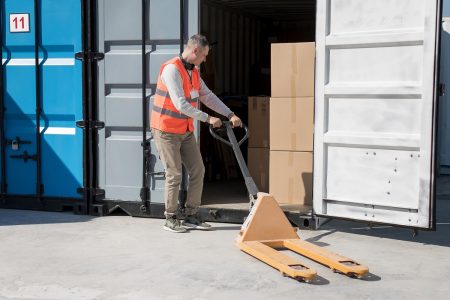 full-shot-man-carrying-pallet-truck.jpg